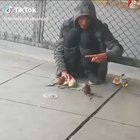 Homeless man teaches different rats multiple tricks.